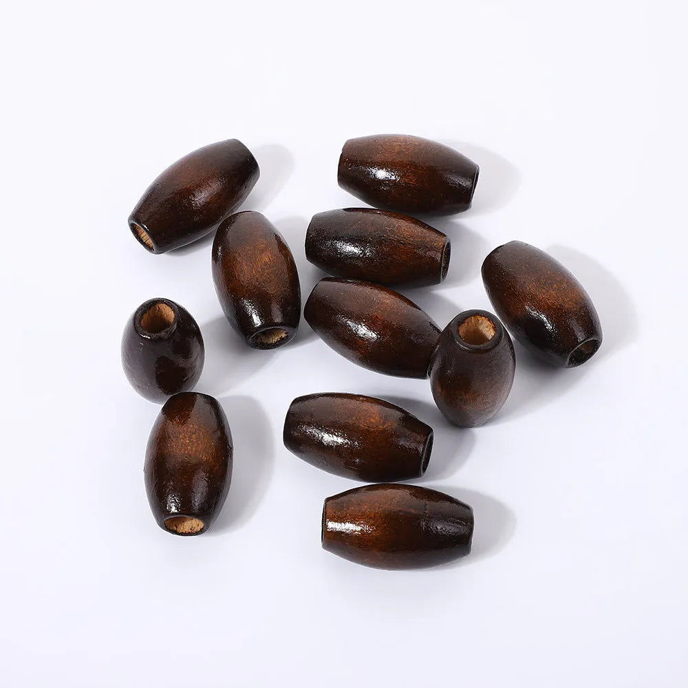 Dark coffee coloured oval wooden bead with an M-shaped raised design on a white background.