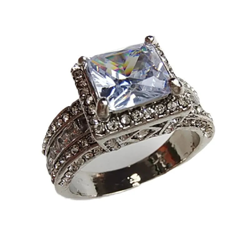 Geometric round women's alloy ring on a hand, showing angular design in gold or white electroplated finish.