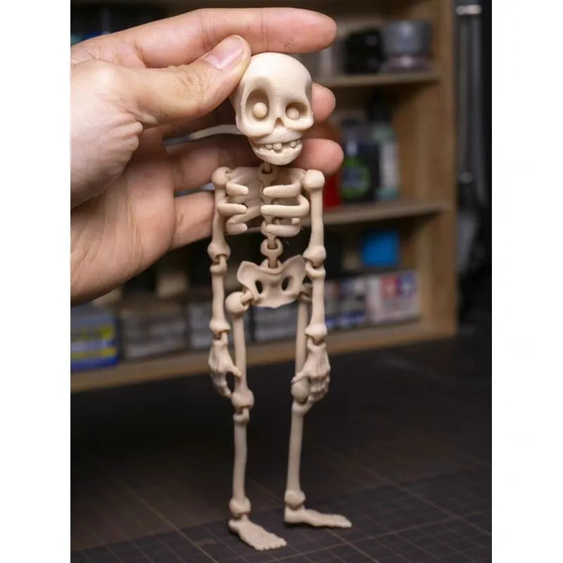 3D printed white skull refrigerator magnet with detailed model on a kitchen fridge.