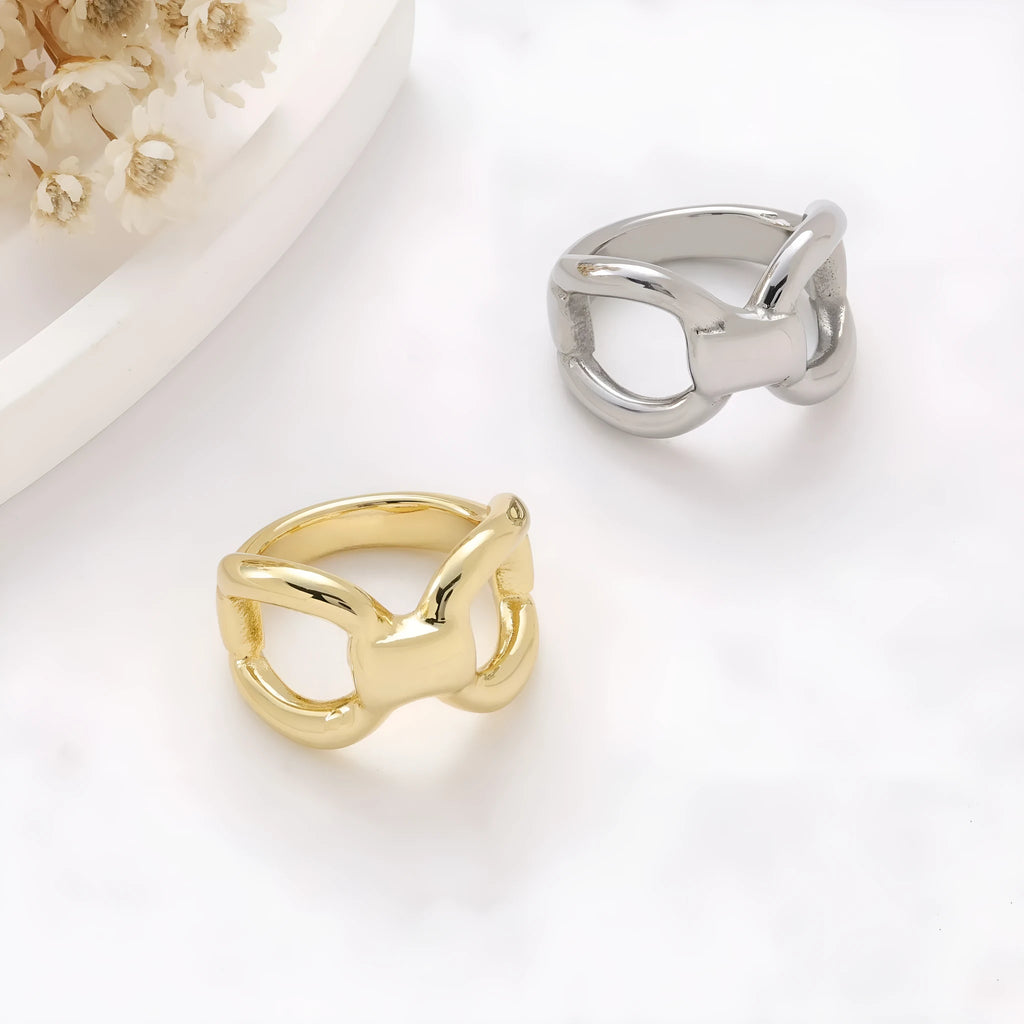 Gold titanium steel women's ring with hollow butterfly and geometric bow design.