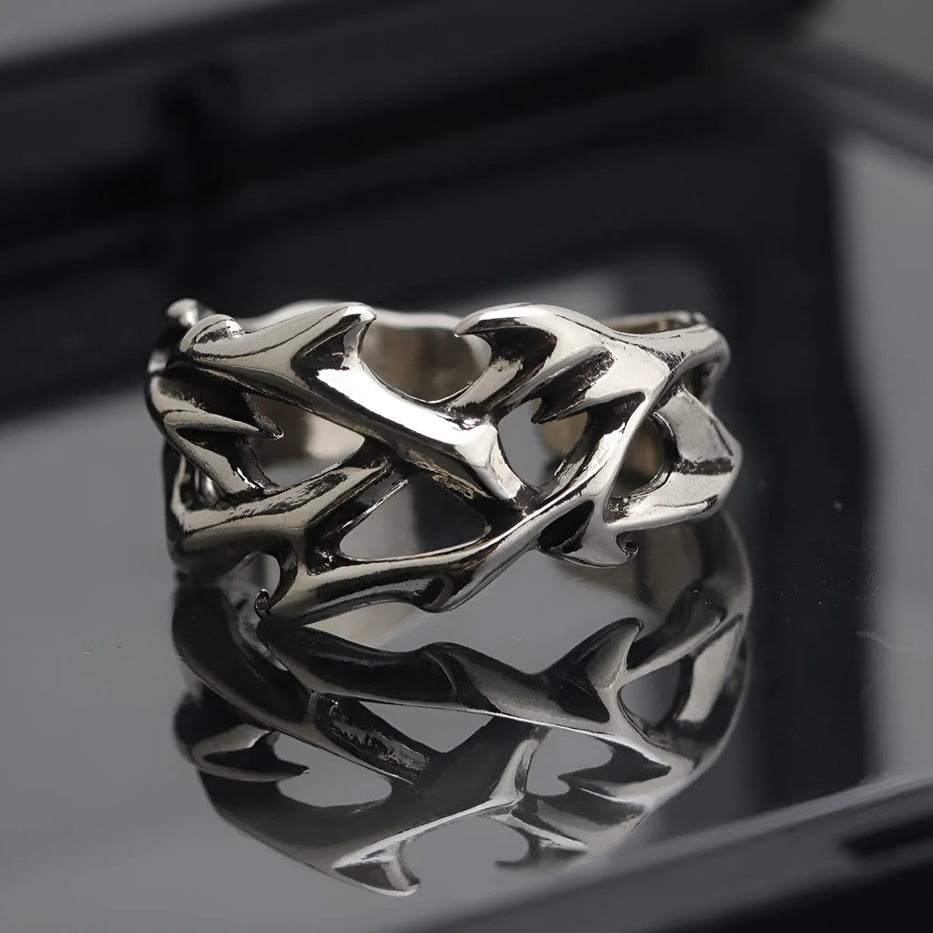 Copper geometric thorn flower ring with adjustable opening on a neutral background.