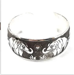 Ethnic carved open Miao silver bracelet with Roman patterns showing elephant and turtle motifs