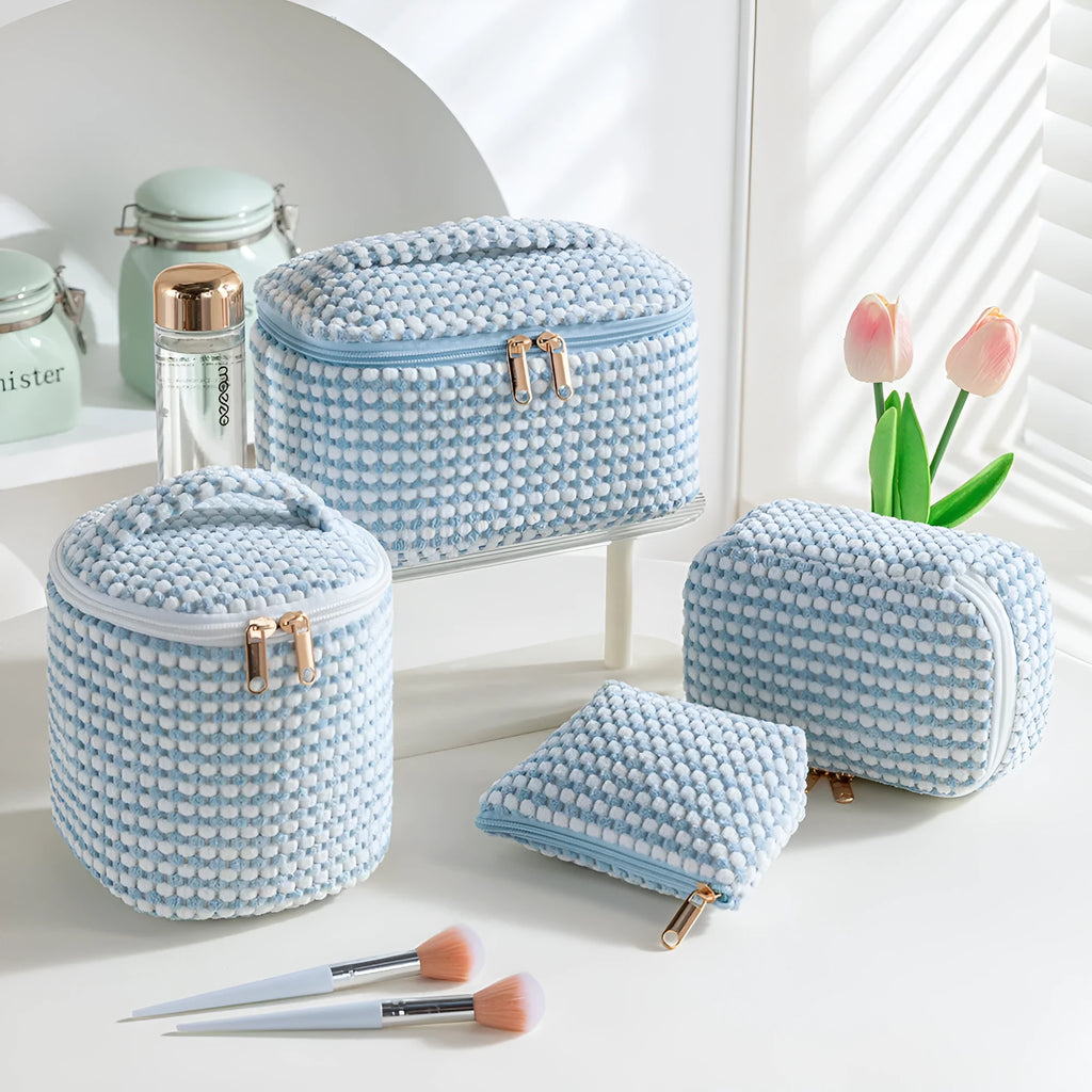 Flannelette makeup bag travel set showing cube-shaped main bag and three smaller zip pouches in a blue with white dots colourway.