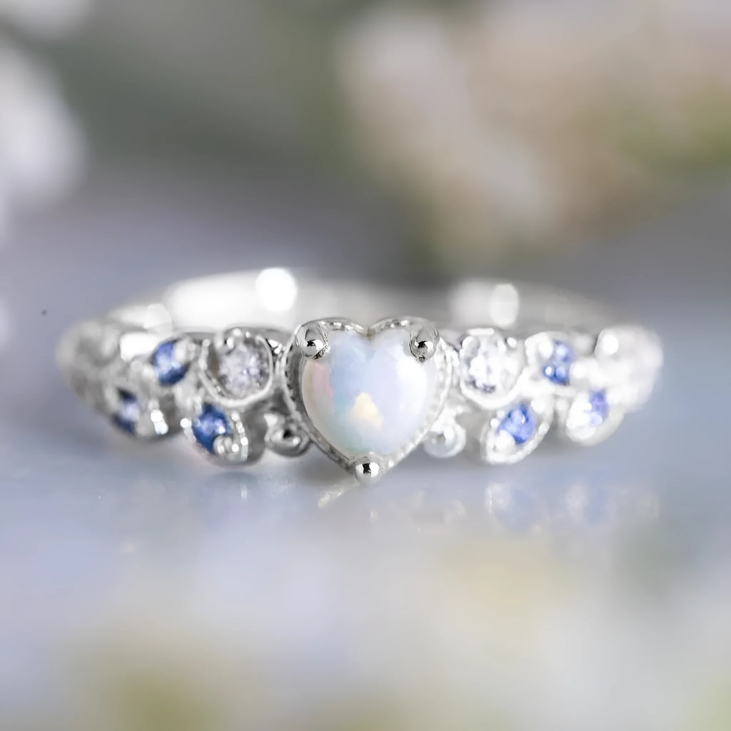 Women's peach-coloured heart-shaped alloy ring with a flower opal ocean pattern on its face.