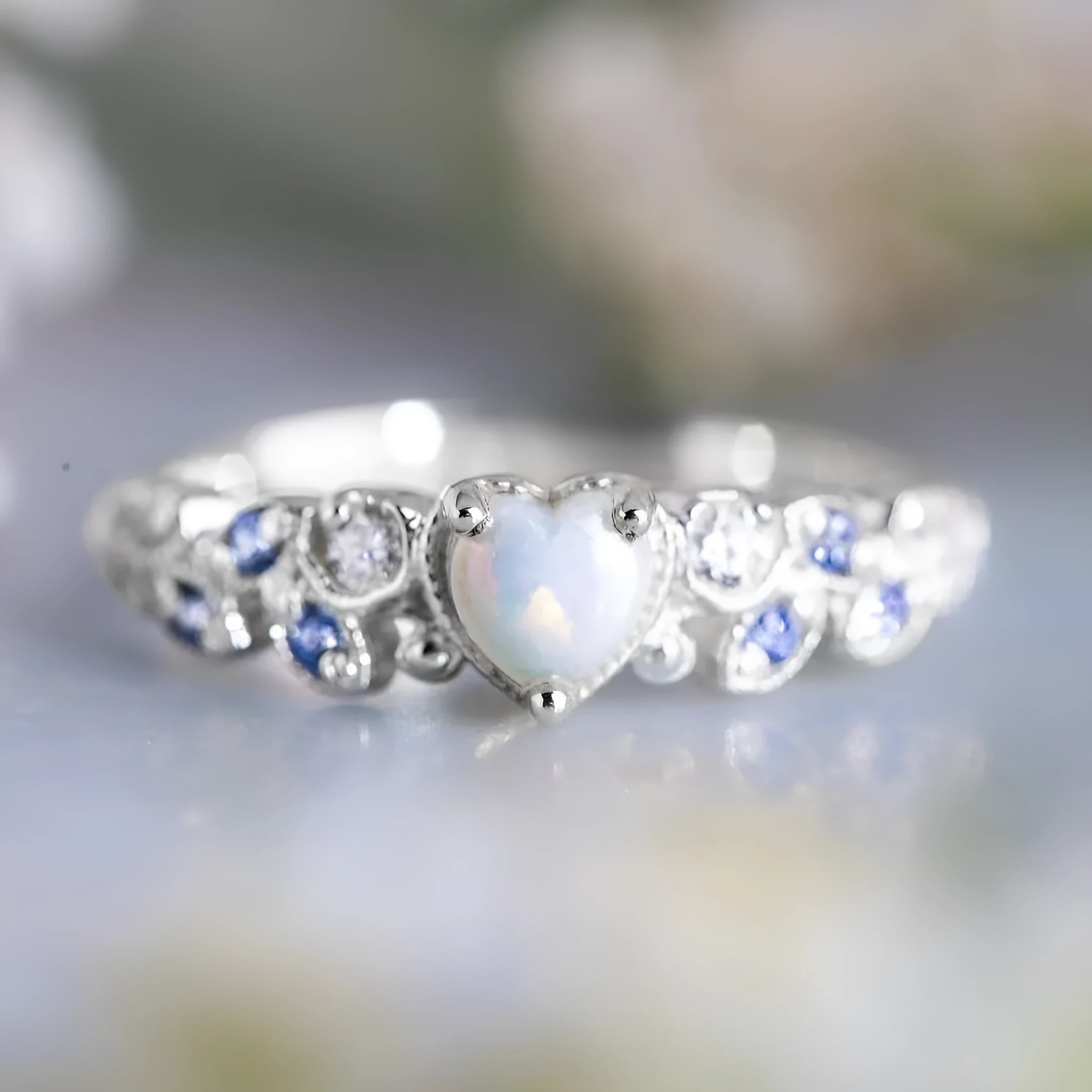 Women's peach-coloured heart-shaped alloy ring with a flower opal ocean pattern on its face.