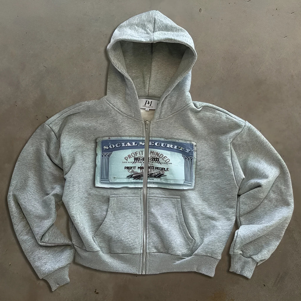 Black loose-fit hoodie jacket with a front zipper and zippered kangaroo pocket on a person.