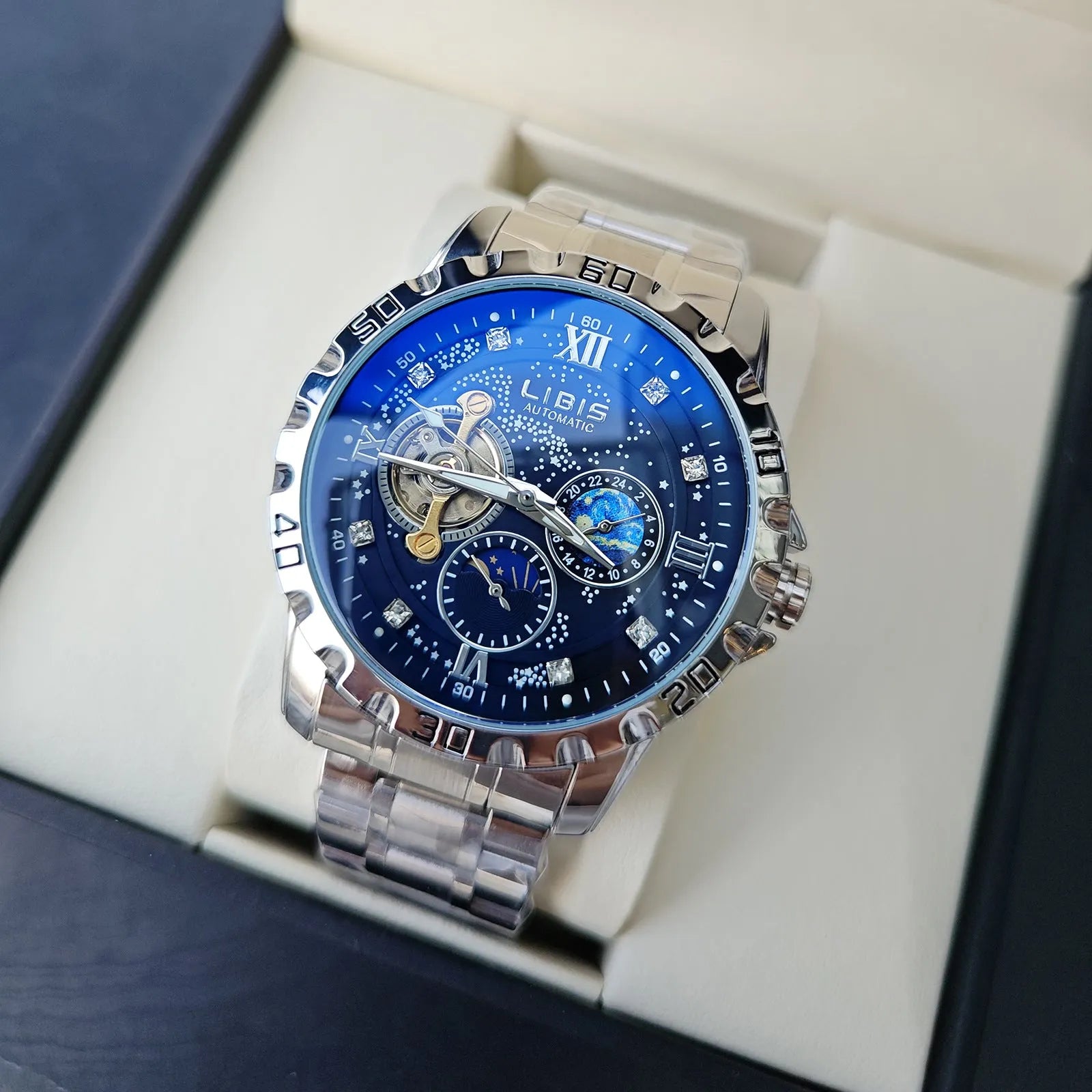 Men's silver case automatic watch with starry black luminous dial and brown leather strap.
