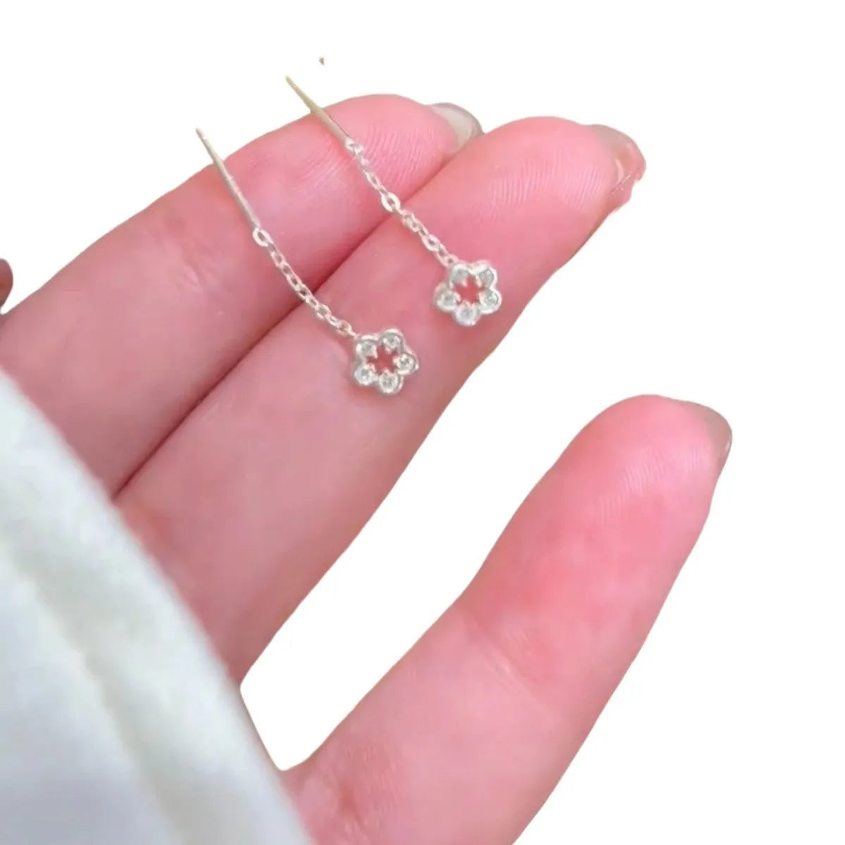 Silver hollow flower hanging earrings with natural petal design on earwire backing
