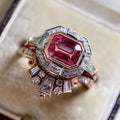 Women's retro-style geometric ruby ring in rose gold alloy on a hand.