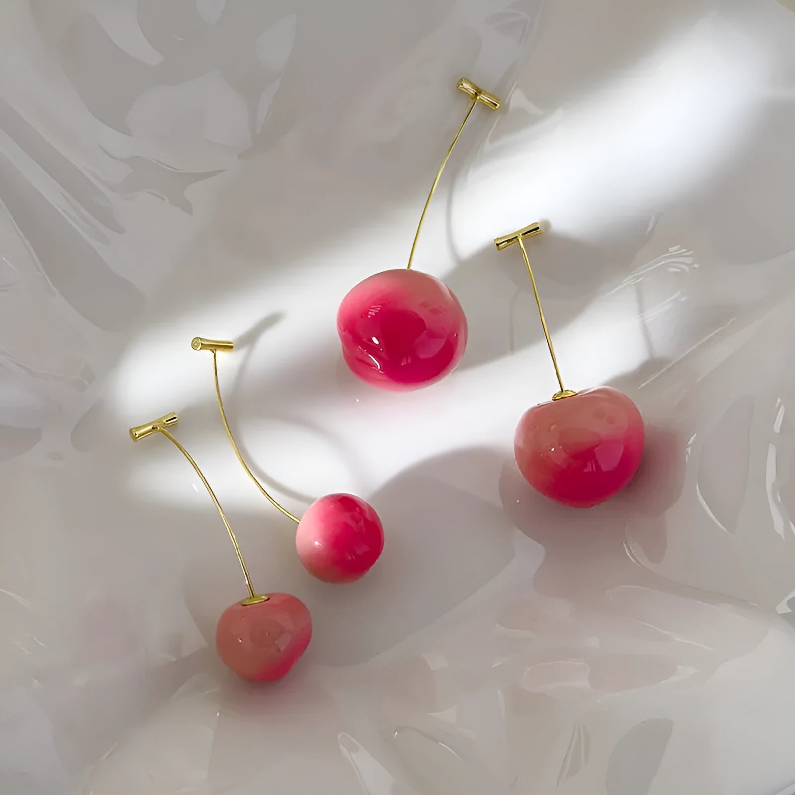A pair of peach-shaped acrylic earrings on copper posts, shown in a choice of large or small sizes.