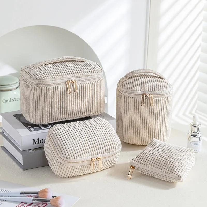 Flannelette makeup bag travel set showing cube-shaped main bag and three smaller zip pouches in a blue with white dots colourway.