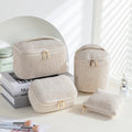 Flannelette makeup bag travel set showing cube-shaped main bag and three smaller zip pouches in a blue with white dots colourway.