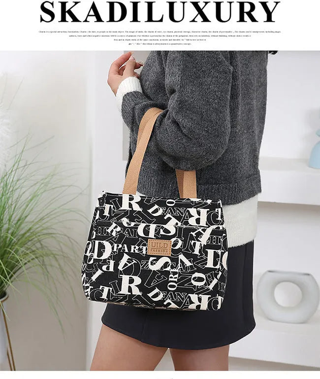Women's large printed canvas tote bag with aluminium hardware in a horizontal square shape.