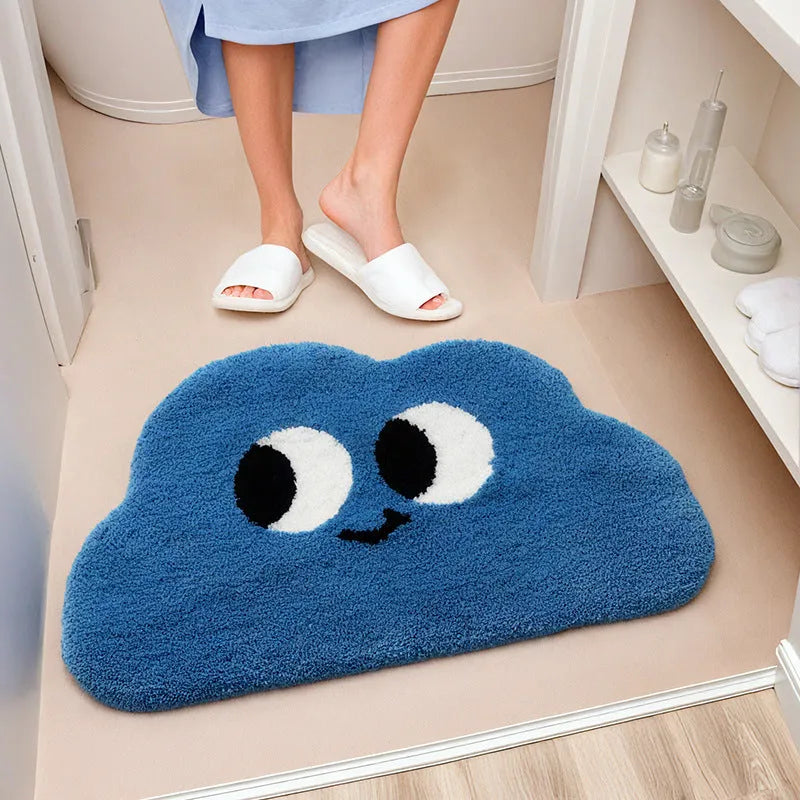 Big eye clouds cartoon print bathroom mat in green, showing soft, thickened polyester fibre pile.