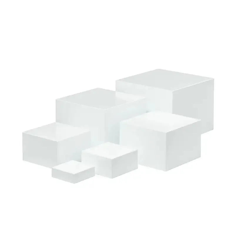 White acrylic six-piece cube dessert display stand arranged on a table with cupcakes.