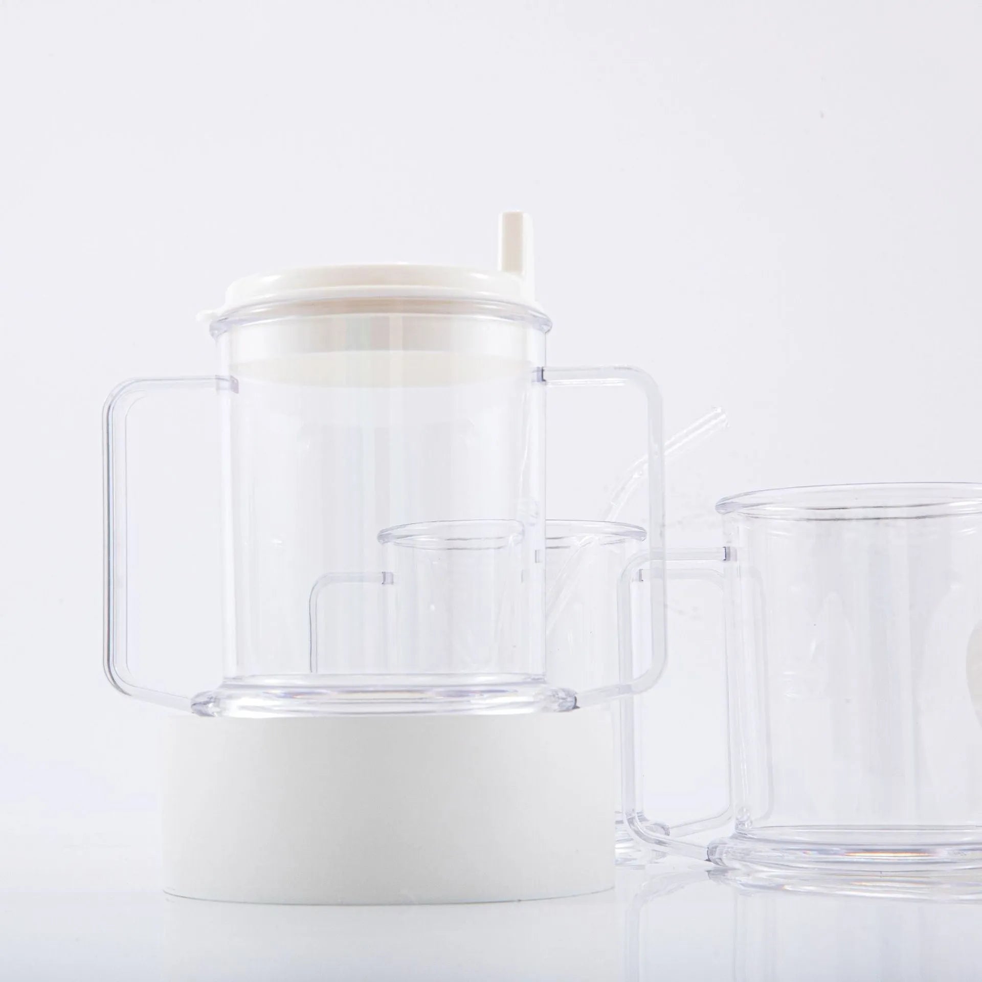 Transparent plastic drinking cup with a simple, modern design on a plain background.