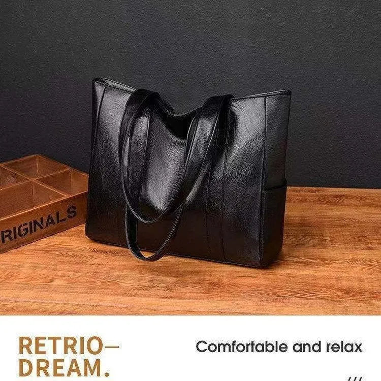 Soft PU horizontal square tote bag with double shoulder straps, black colour, sewing thread detail, and sandwich pocket