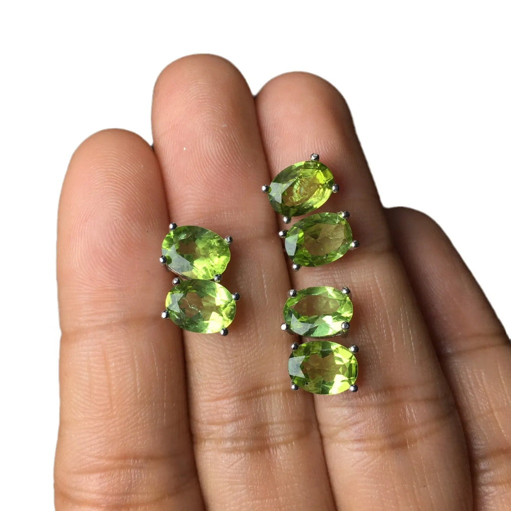 Close-up of natural grass green olivine stud earrings in S925 silver setting.