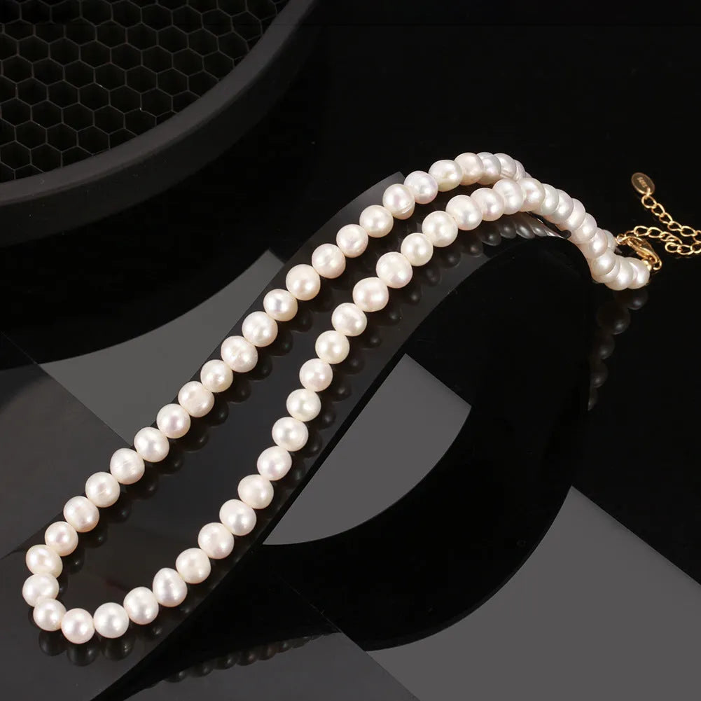 Close-up of a women's adjustable silver necklace with a natural freshwater pearl centrepiece.