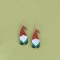 Santa Claus cartoon character acrylic fashion earrings on red, green, and mixed backgrounds.