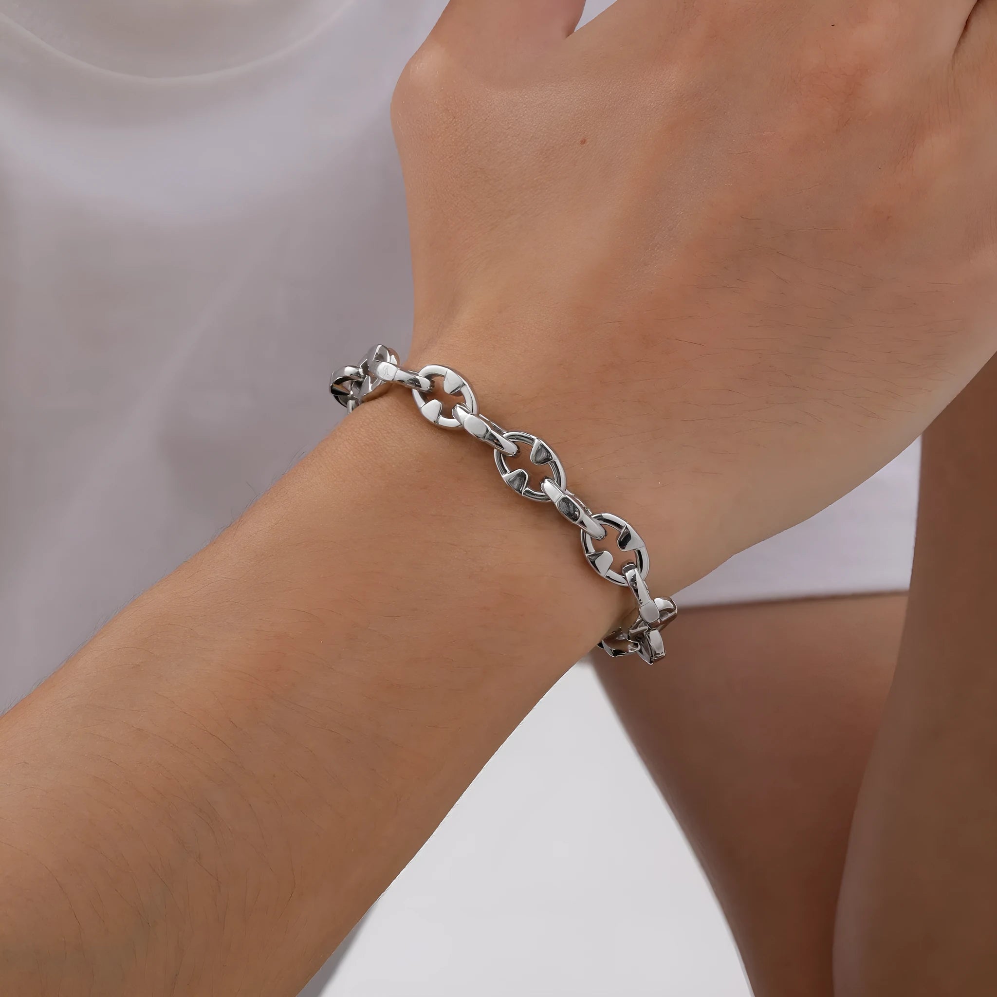 A thick stainless steel geometric chain bracelet for men, shown on a wrist.