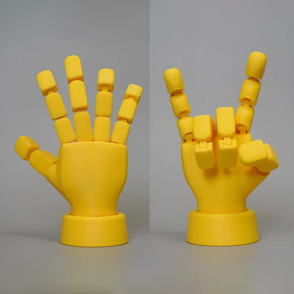 Yellow articulated hand ornament with movable joints on a white background.
