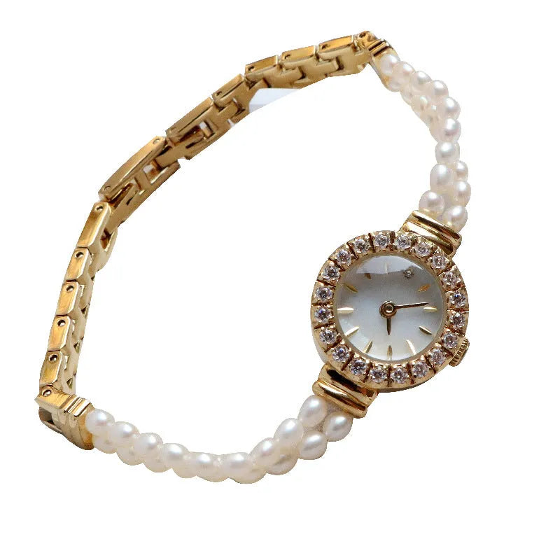 Women's light gold bracelet watch with natural freshwater pearls on a stainless steel strap, showing an 18mm round dial.
