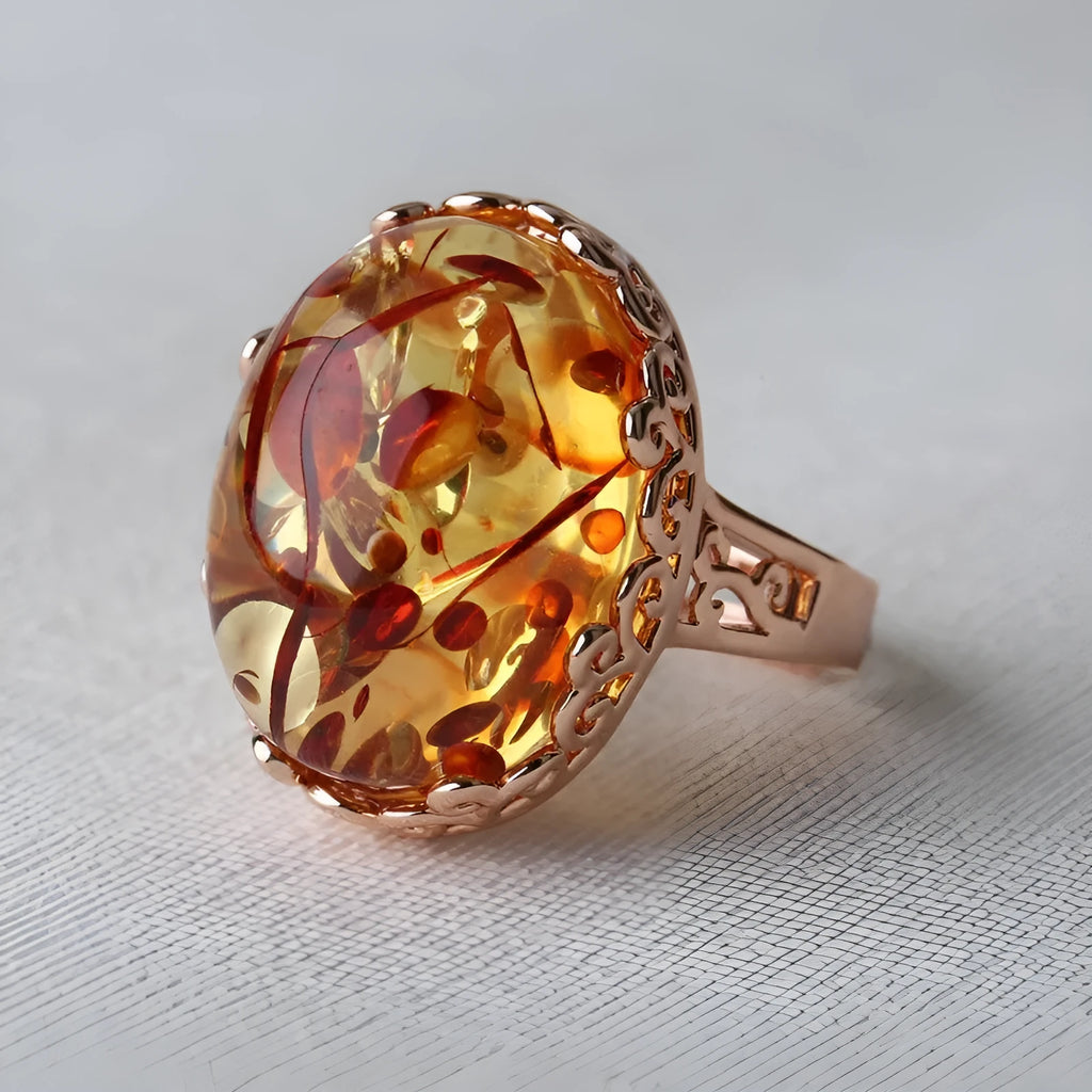 Unisex amber beeswax ring with carved design on an alloy band in New Amber Type A colour.
