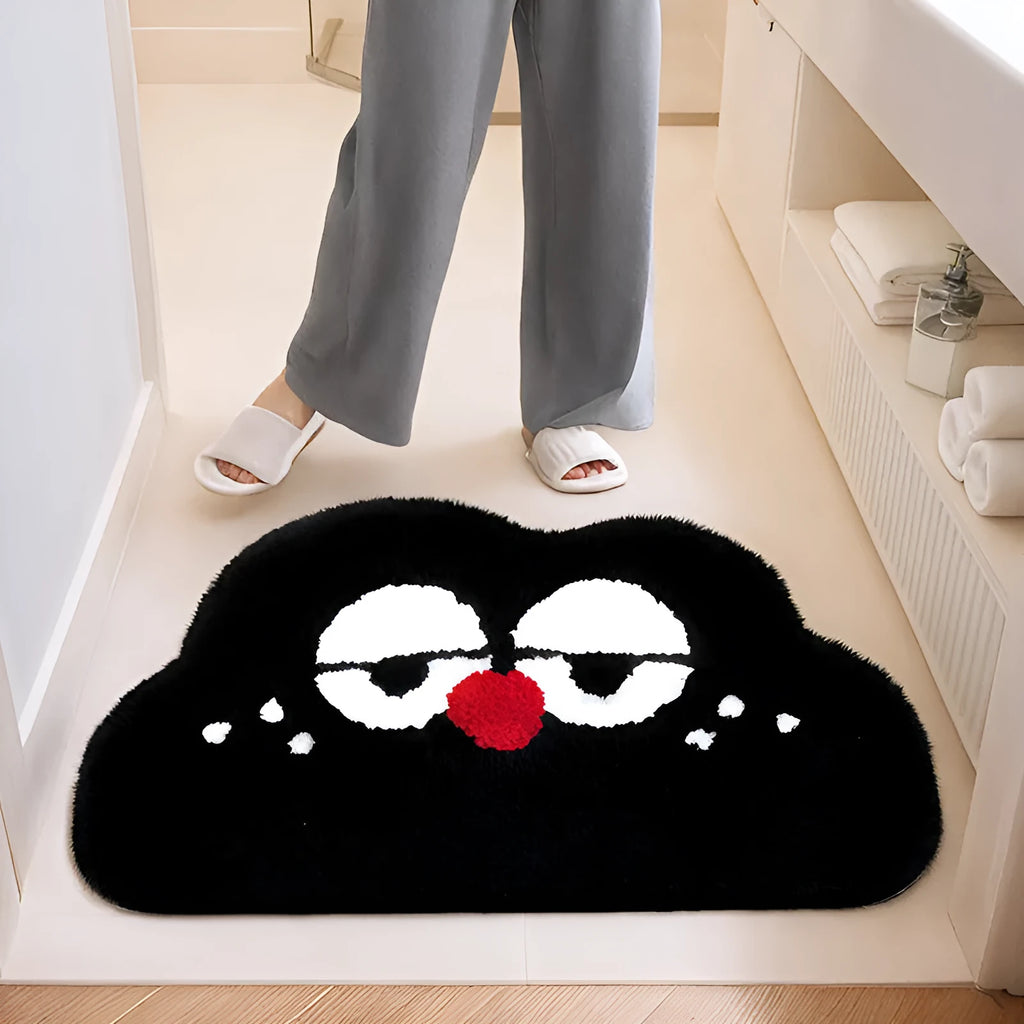 Big eye clouds cartoon print bathroom mat in green, showing soft, thickened polyester fibre pile.