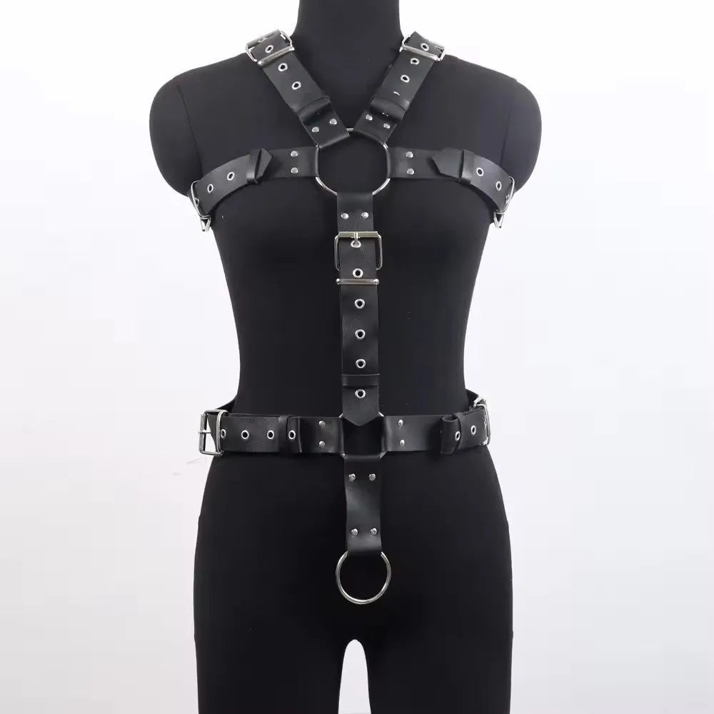 Black patent leather thin waist-cinching belt with a pin buckle on a mannequin.