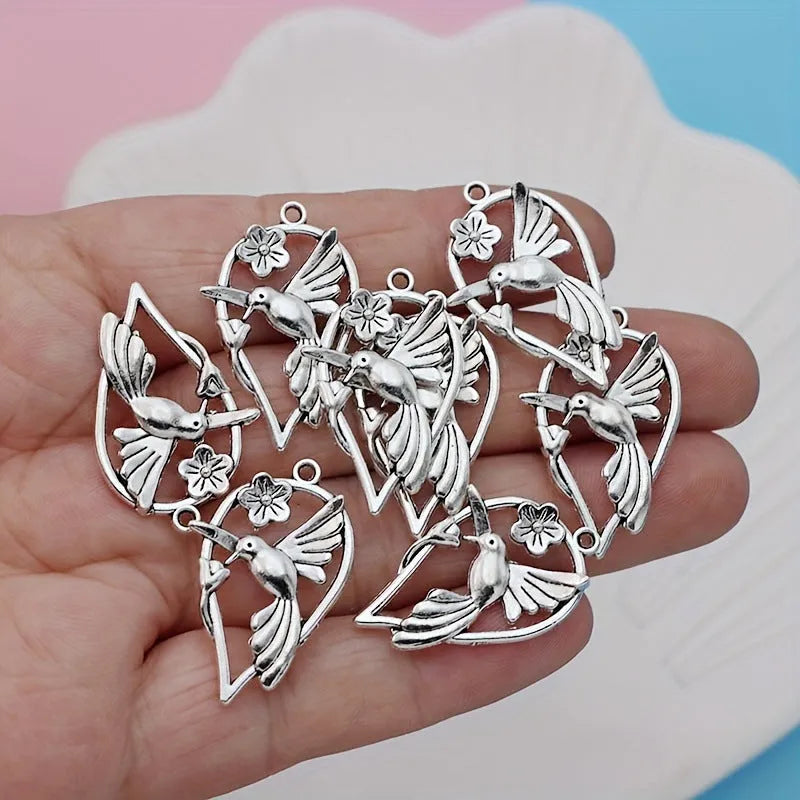 Close-up of a detailed magpie pattern alloy pendant with electroplated finish, showing attachment loop for DIY jewellery.