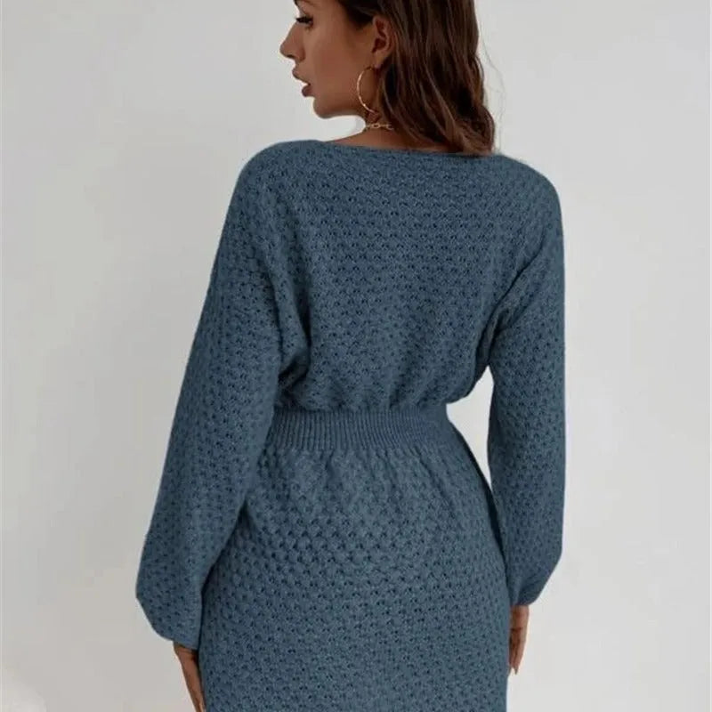 Blue women's knitted dress with crocheted flower details on the front.