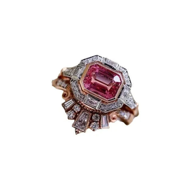 Women's retro-style geometric ruby ring in rose gold alloy on a hand.
