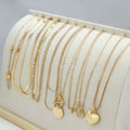 Gold tone women's necklace set with 10 ornamental pieces on snake bone chain
