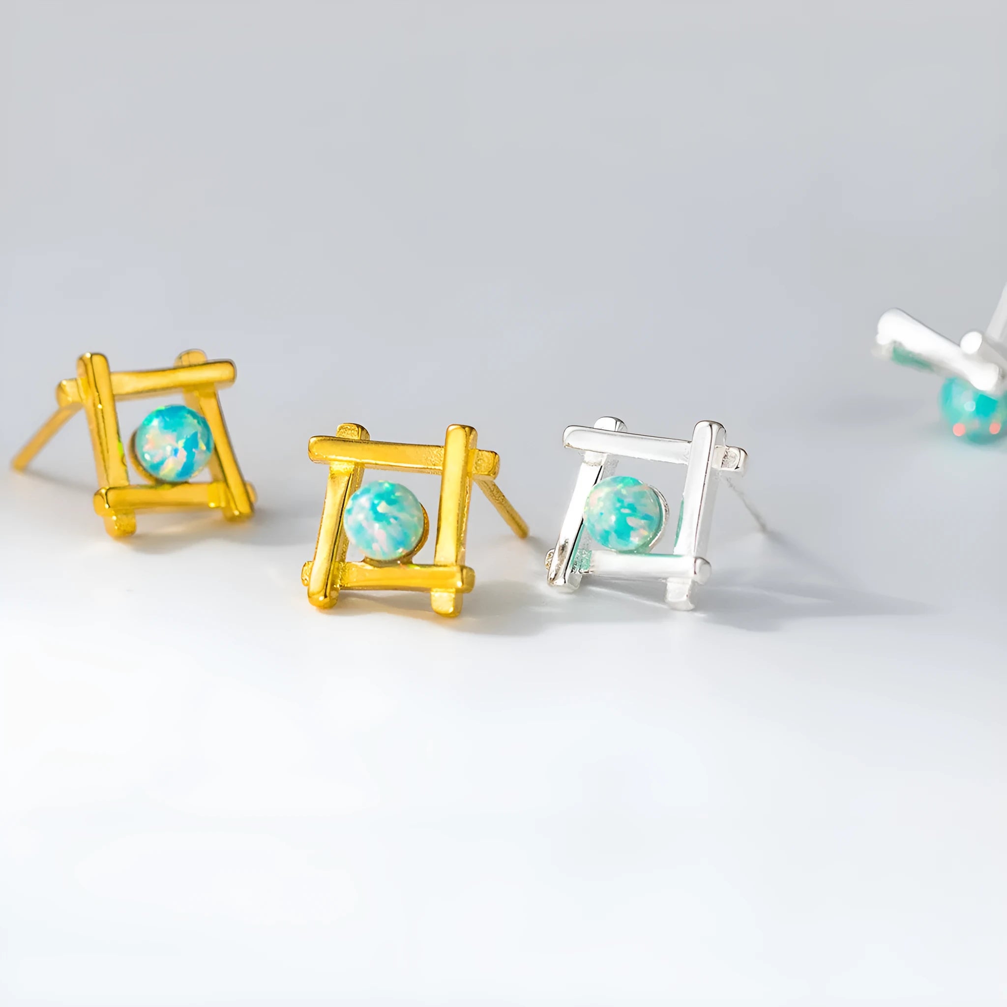 Geometric cross-shaped 925 silver stud earrings in gold and silver tone options.