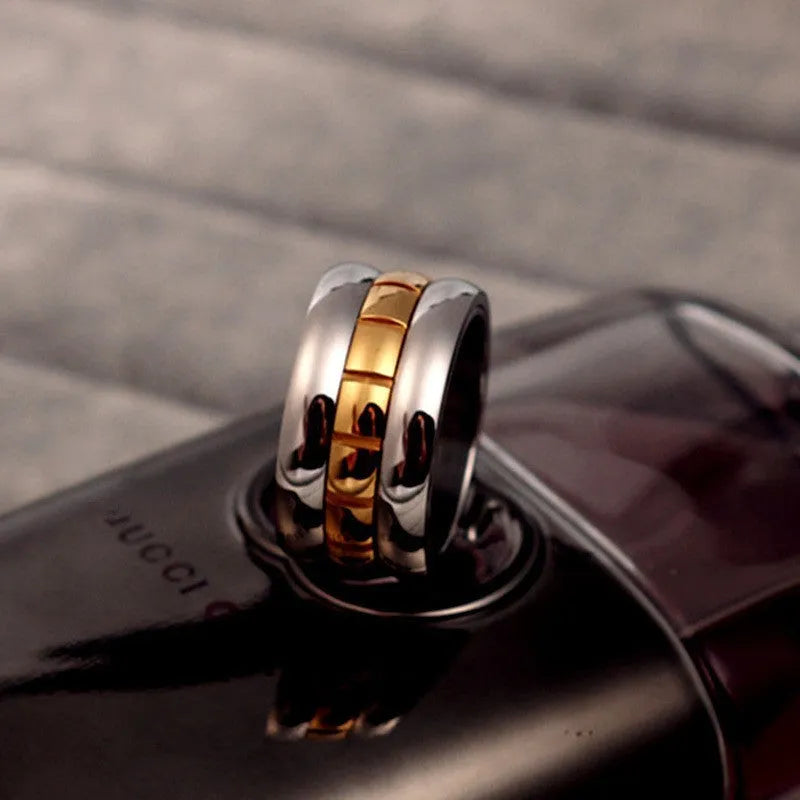 Gold titanium steel ultra-wide knuckle ring with a rotatable tail on a hand