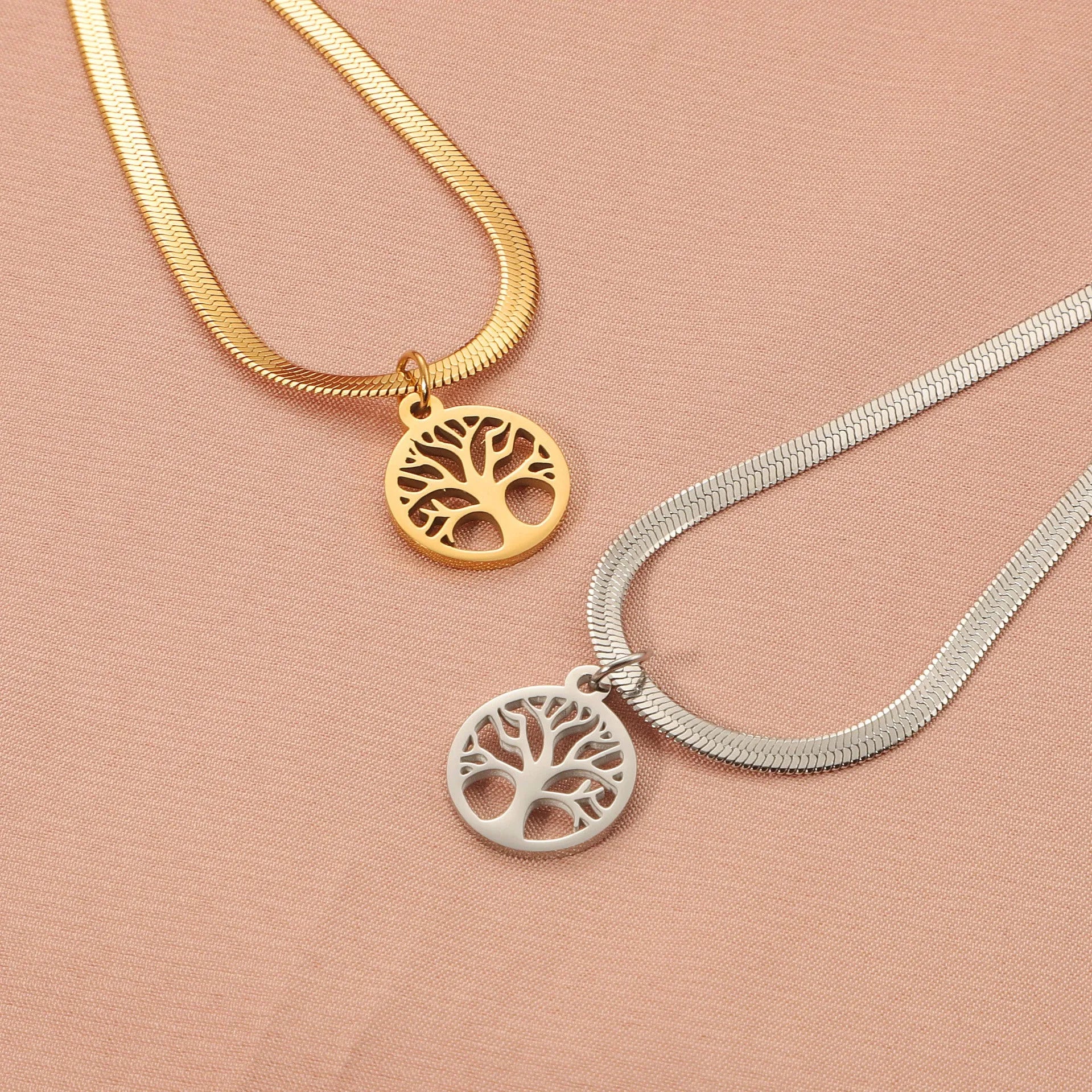Stainless steel adjustable lucky tree necklace with a snake bone chain on a white background.