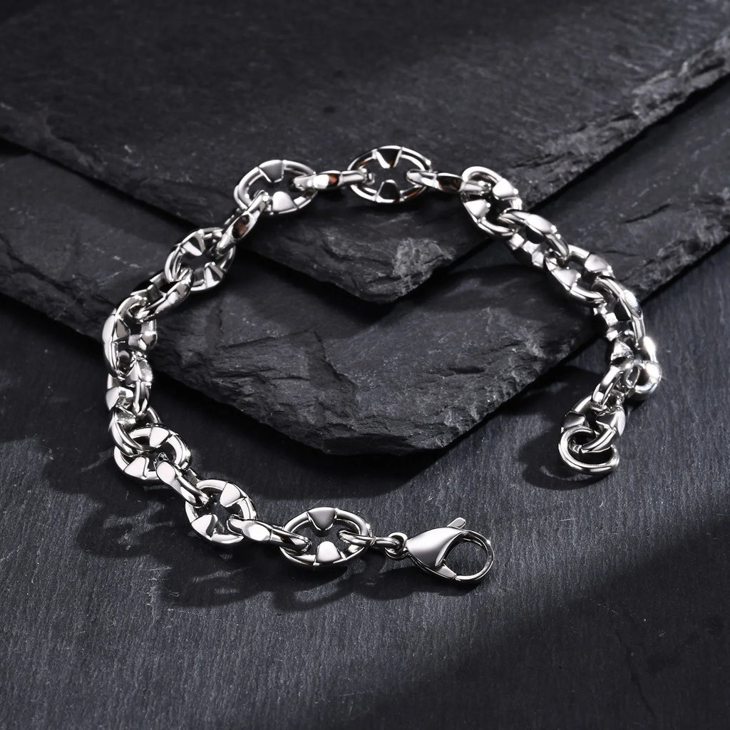 A thick stainless steel geometric chain bracelet for men, shown on a wrist.