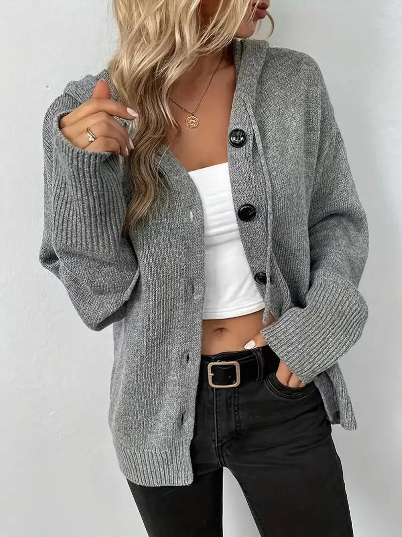 A solid colour loose-fit hooded cardigan sweater made from thick cotton fabric.