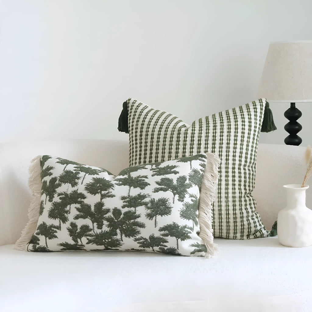 Green cotton and linen hotel pillow with decorative tassels and botanical patterns, shown with pillowcase and silk floss core.