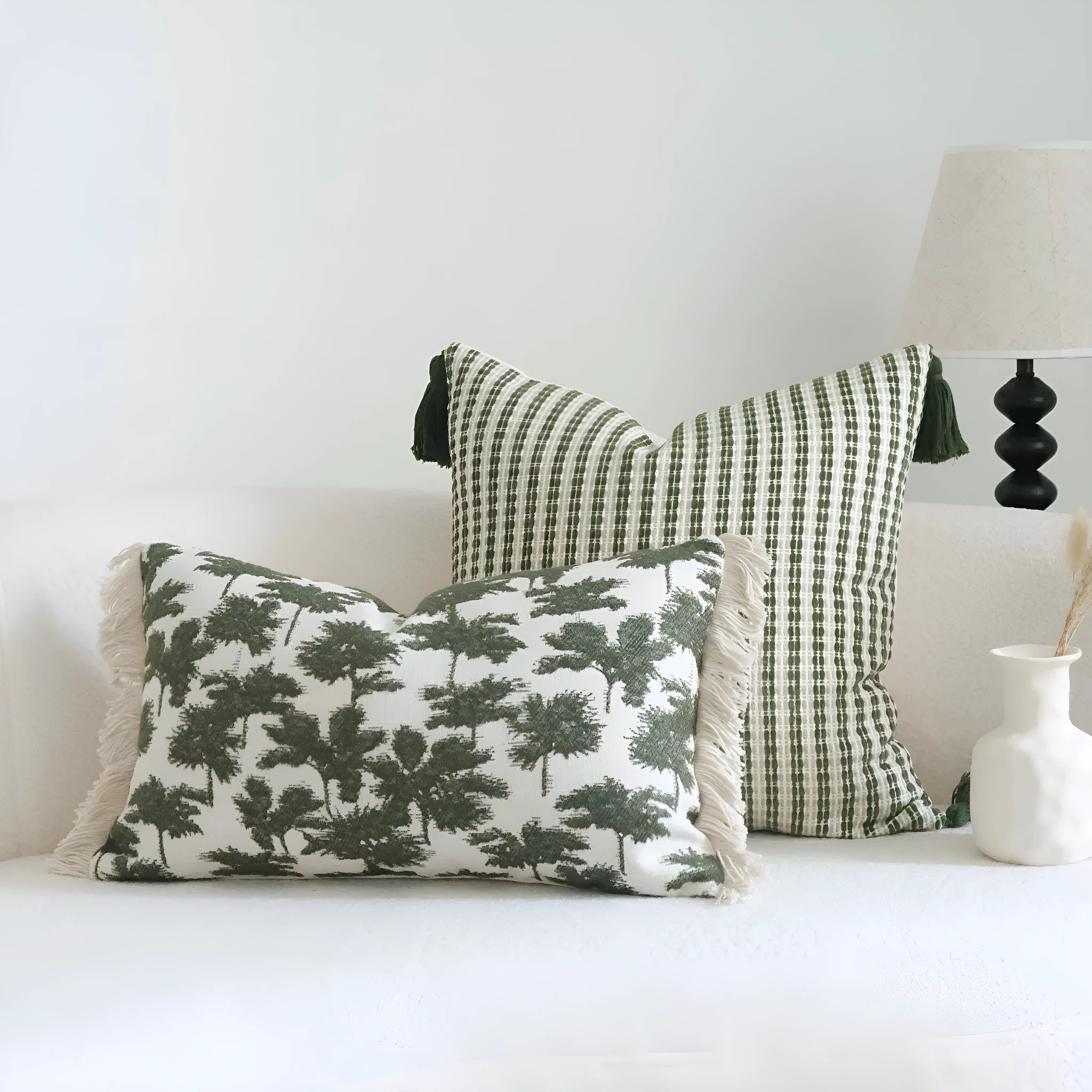 Green cotton and linen hotel pillow with decorative tassels and botanical patterns, shown with pillowcase and silk floss core.