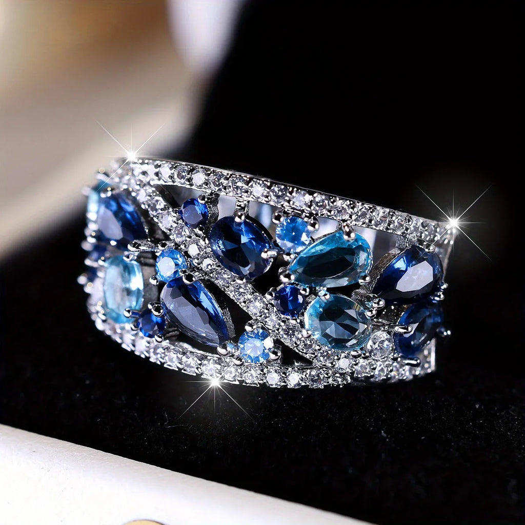 Round hollow women's fashion ring in copper, shown in platinum white and gold blue colour options.