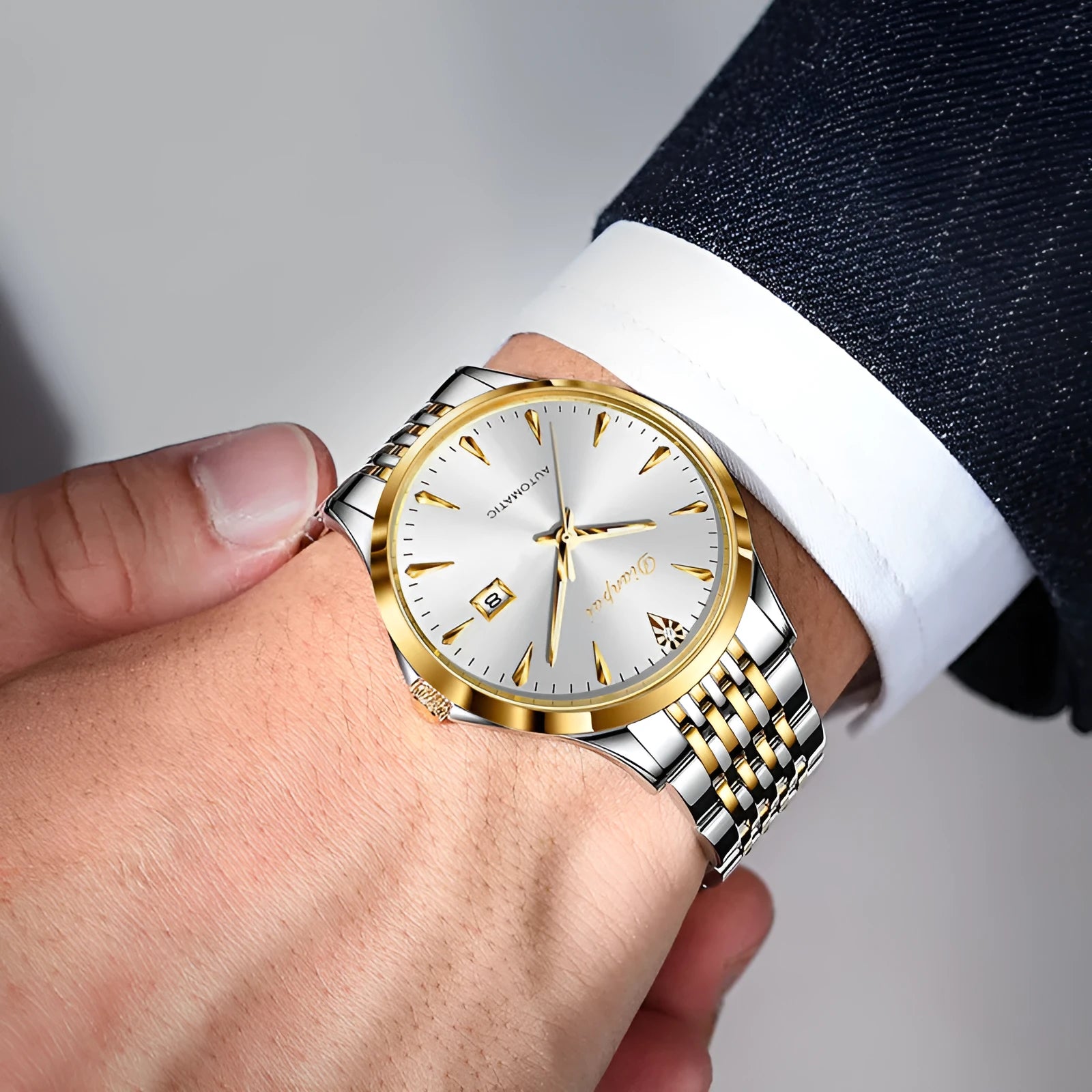 Men's simple dial automatic watch in stainless steel on wrist, showing golden black colour option.