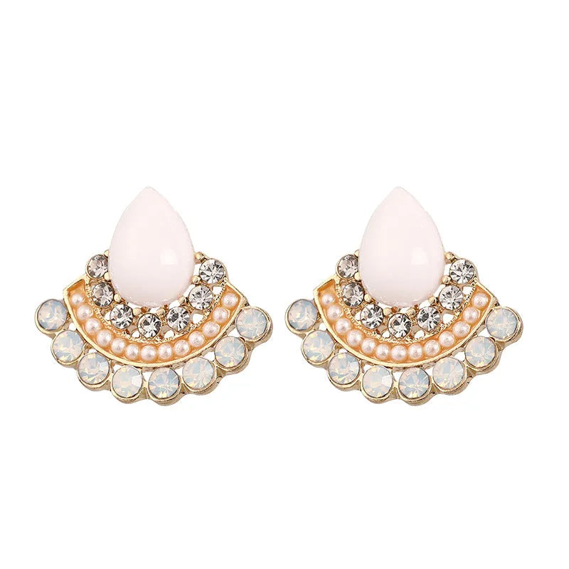 Close-up of women's retro silver fan-shaped rhinestone earrings with needle posts.