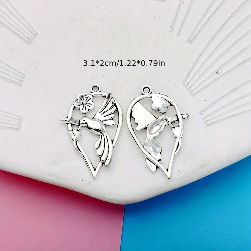Close-up of a detailed magpie pattern alloy pendant with electroplated finish, showing attachment loop for DIY jewellery.