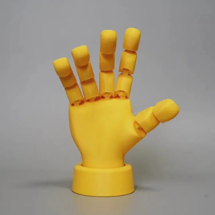 Yellow PLA hand ornament with movable joints for display, measuring 5 by 5.38 by 7.5 cm.