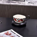 Black and orange antique style ceramic coffee cup and saucer set with 210ml capacity.