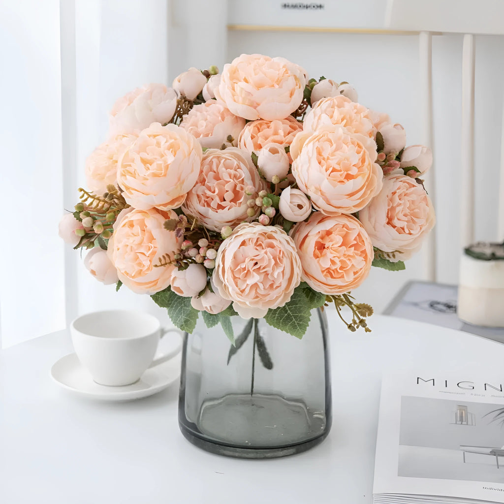 Artificial silk peony bouquet in a vase, showing realistic pink petals and green leaves for home decor.