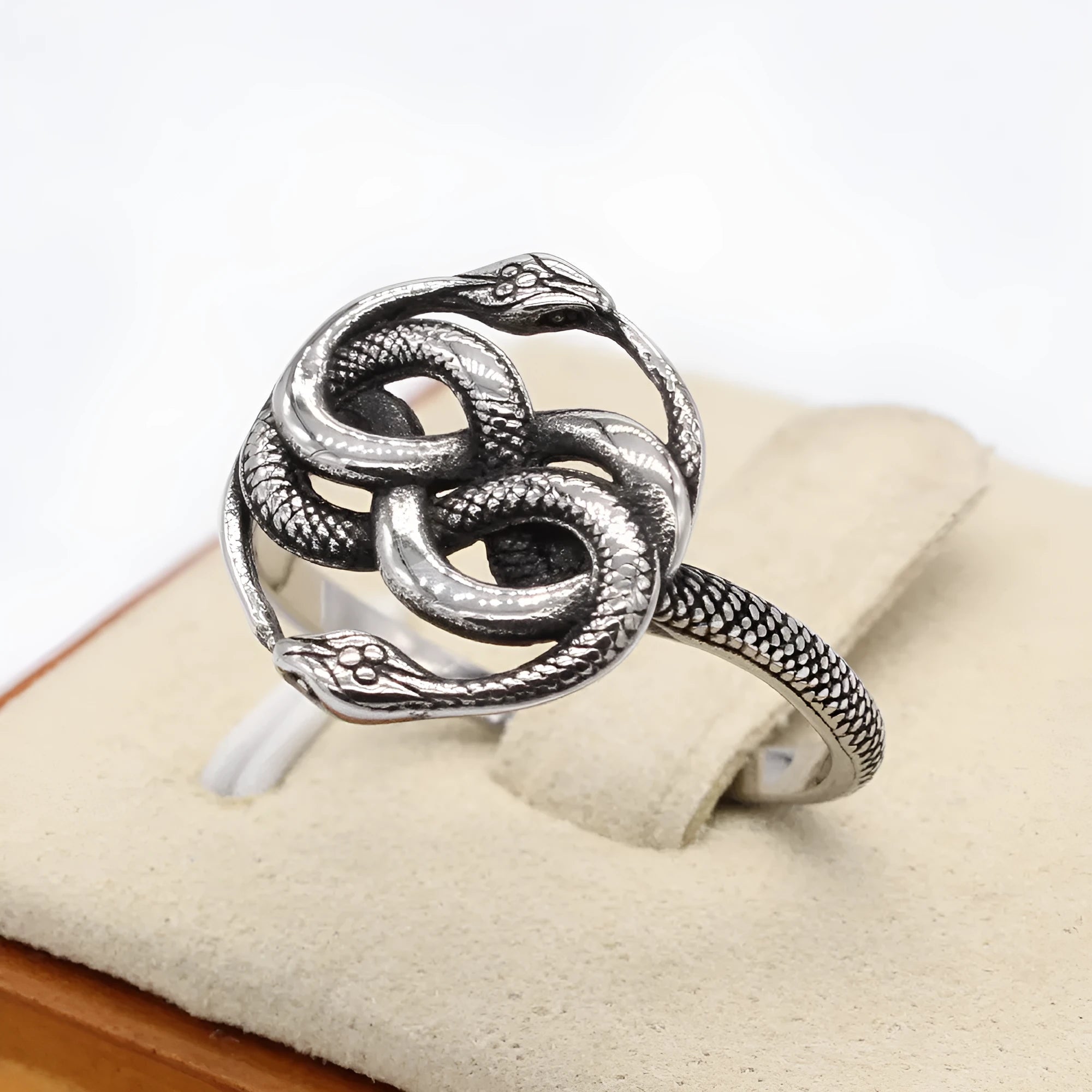 Personalised titanium steel double snake ring in steel colour on a grey background.