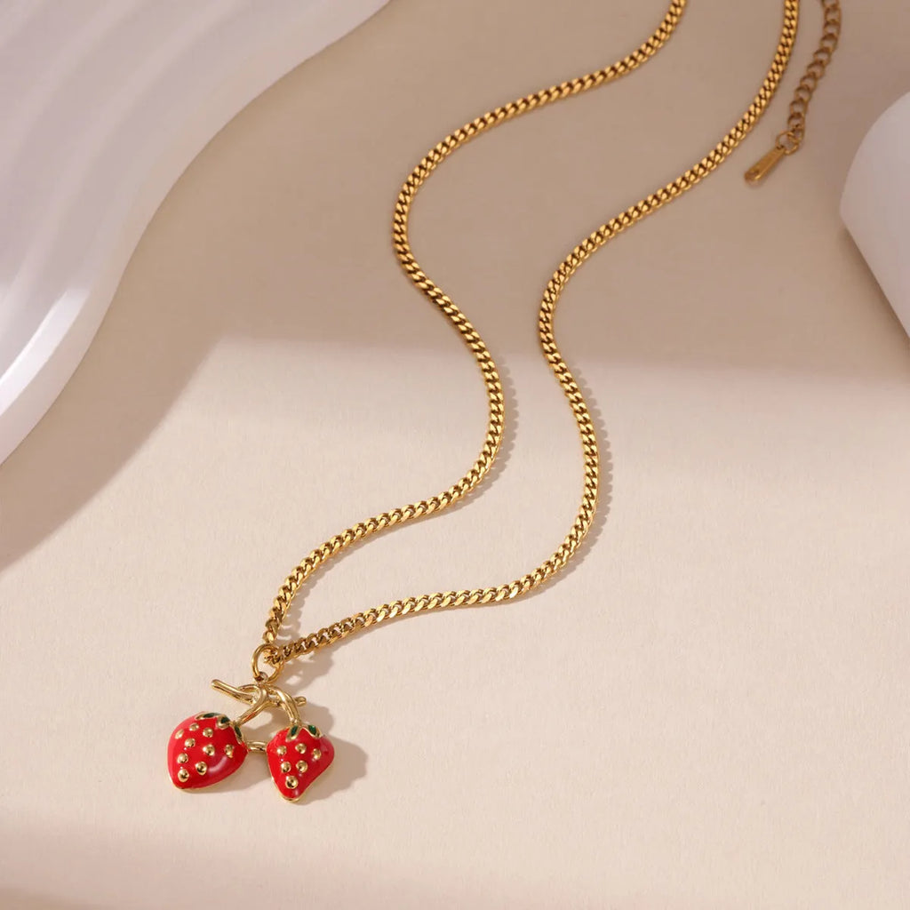 Strawberry fruit charm pendant necklace in stainless steel alloy, shown in red and white gradient colour options.